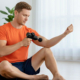 A man using a massage gun on his arm.