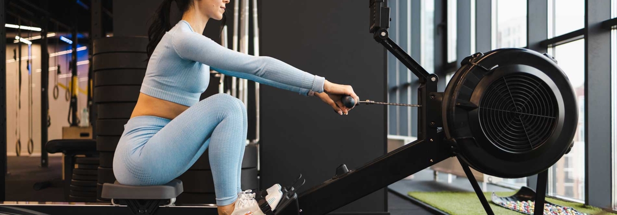 Woman doing exercise on rowing machine