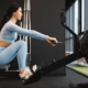 Woman doing exercise on rowing machine