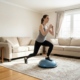 Woman doing exercise using half ball balance at home